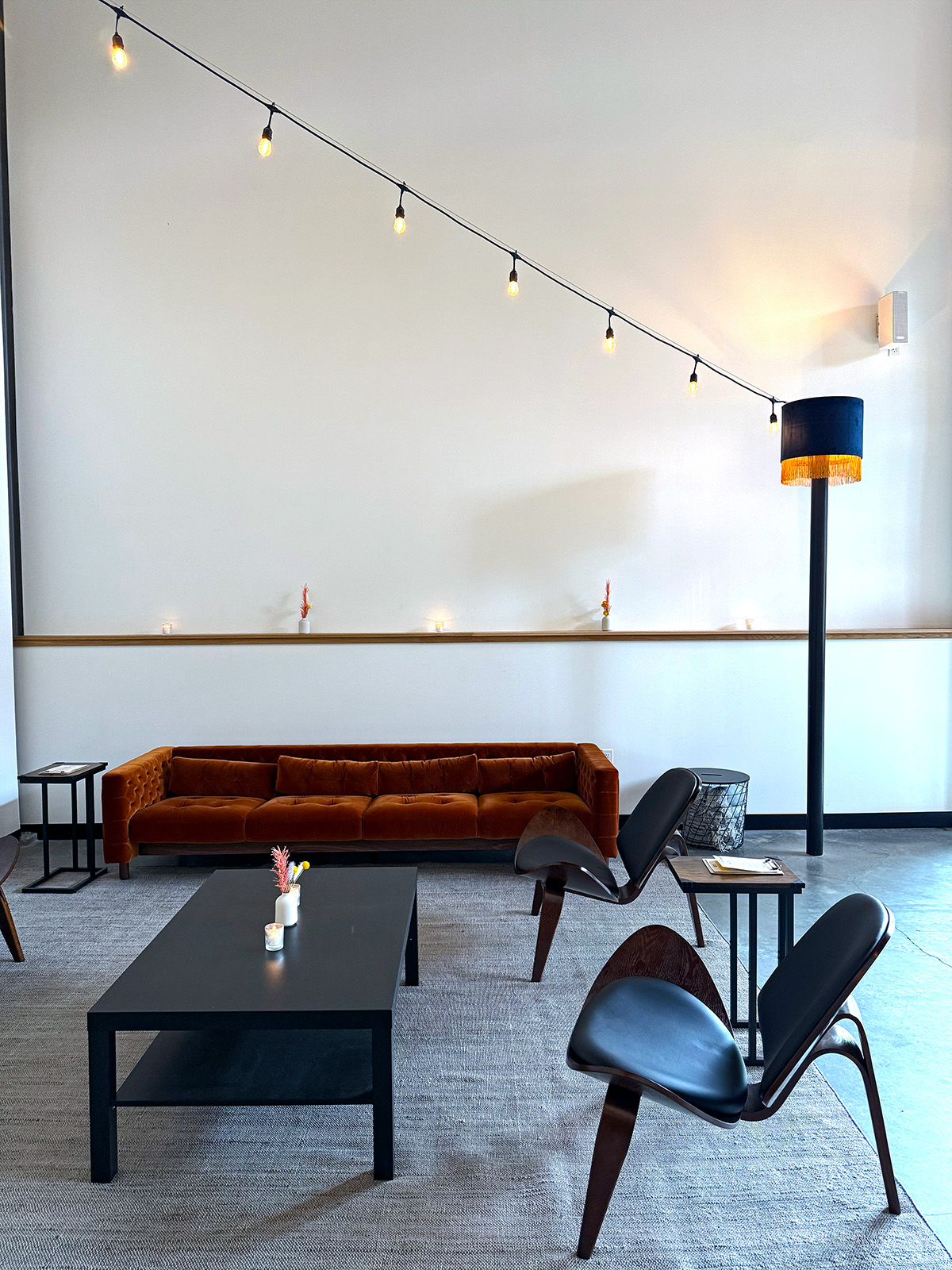 minimalist seating area at a winery with a couch, chairs, and coffe table