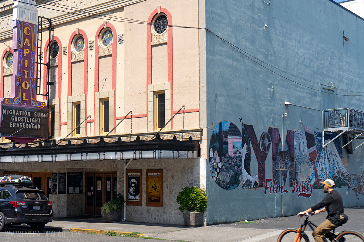 person biking by the Capitol Theater in Olympia, WA