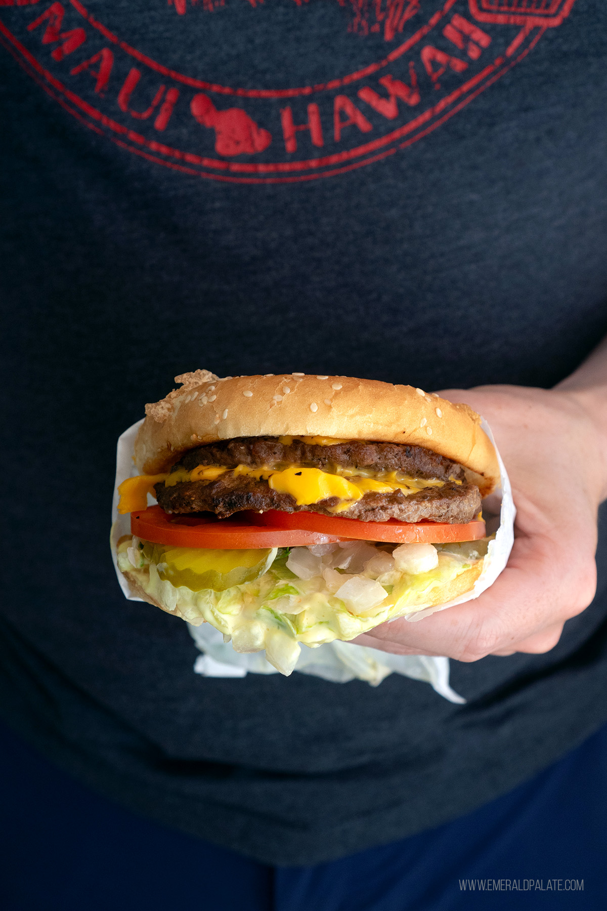 man holding a burger from one of Olympia's best restaurants