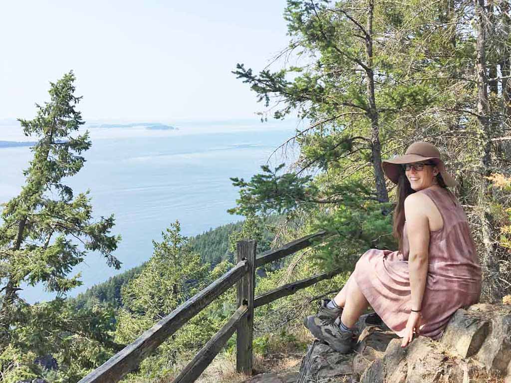Woman sitting on top of Bakers Preserve on an island off Seattle