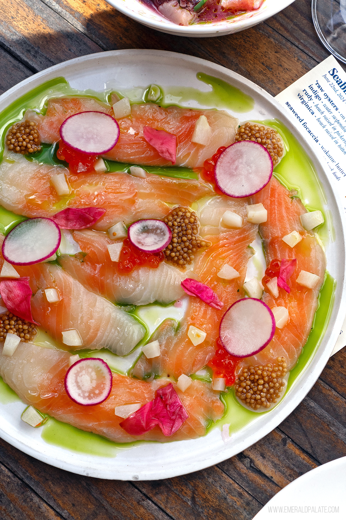 plate of salmon lox with roe, radish, mustard seeds, and basil oil from a restaurant on Bainbridge Island, WA