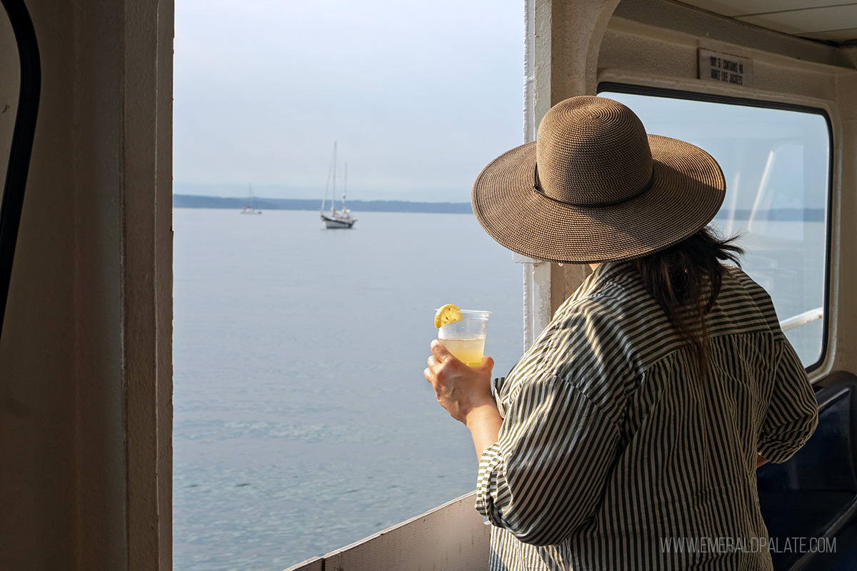 woman enjoying a drink and views on an Argosy Cruise, one of the best things to do in Washington state