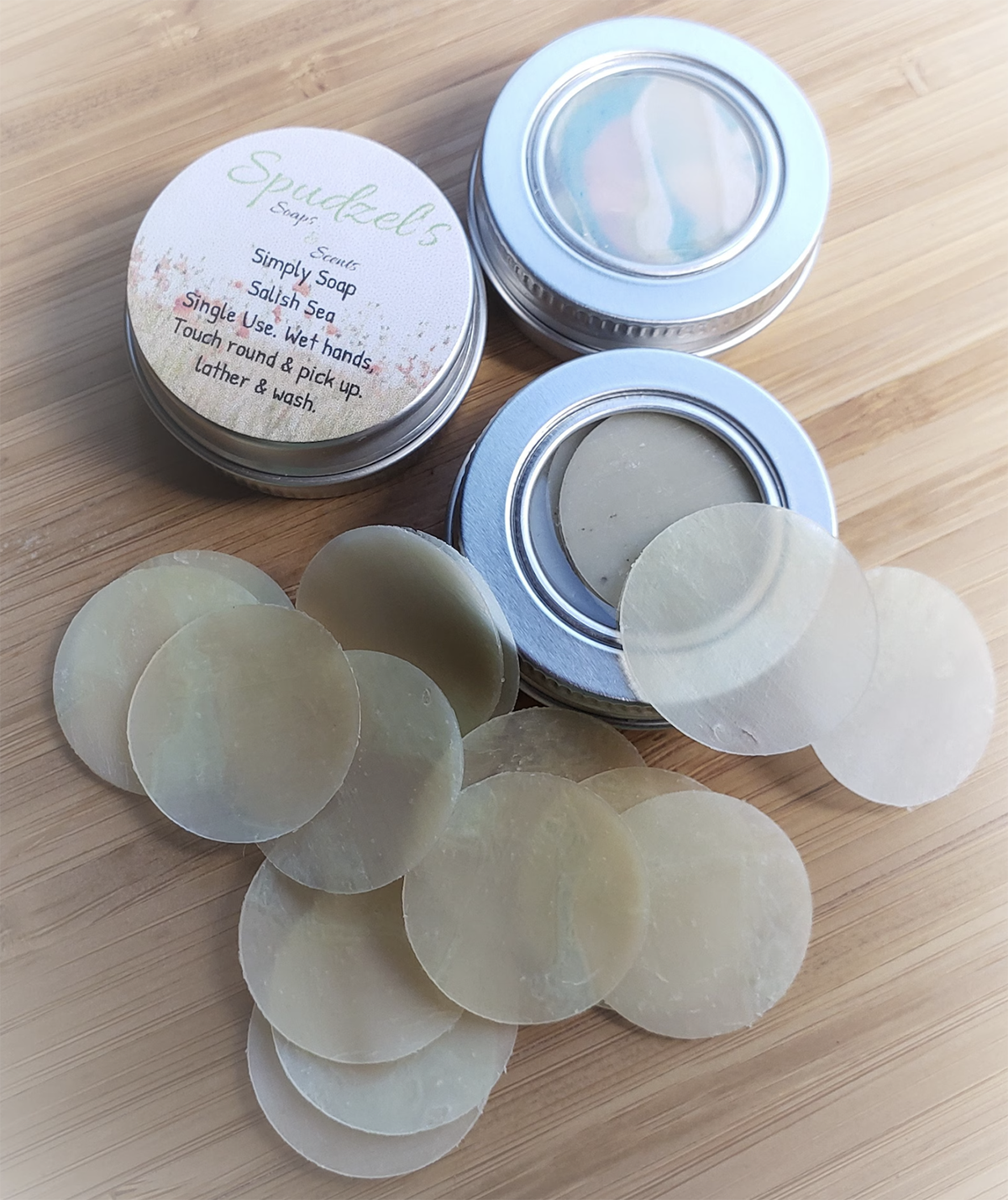 An open container of single-use soap sheets on a wooden counter