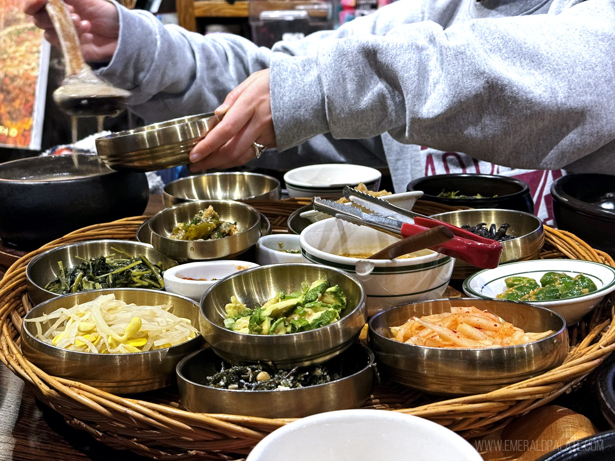 person spooning tofu soup at one of the most unique restaurants in Los Angeles