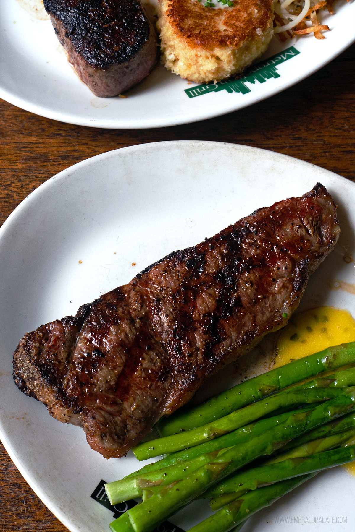 steak with grill marks on a plate with asparagus
