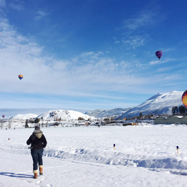 Woman at a hot air balloon festival at one of the best winter getaways in Washington state