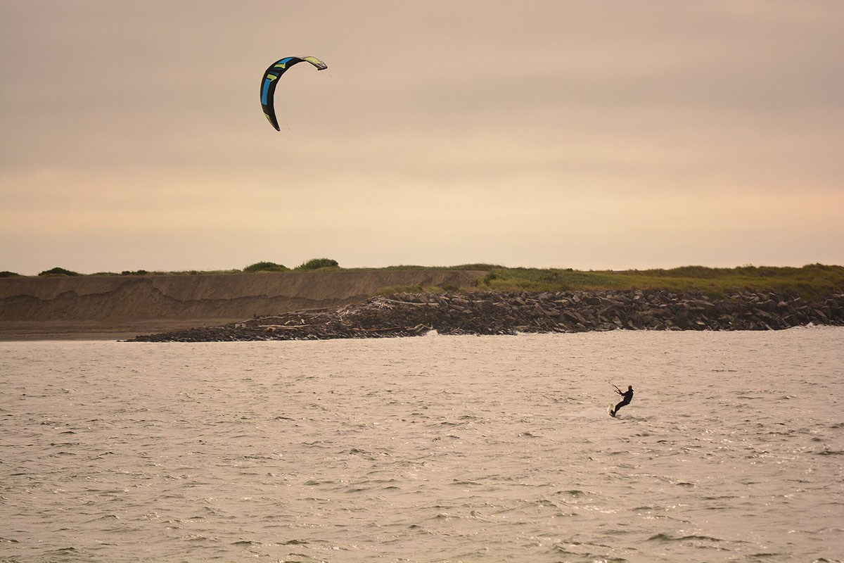 Person windsurfing on Westport Beach, one of the best summer vacations in Washington state