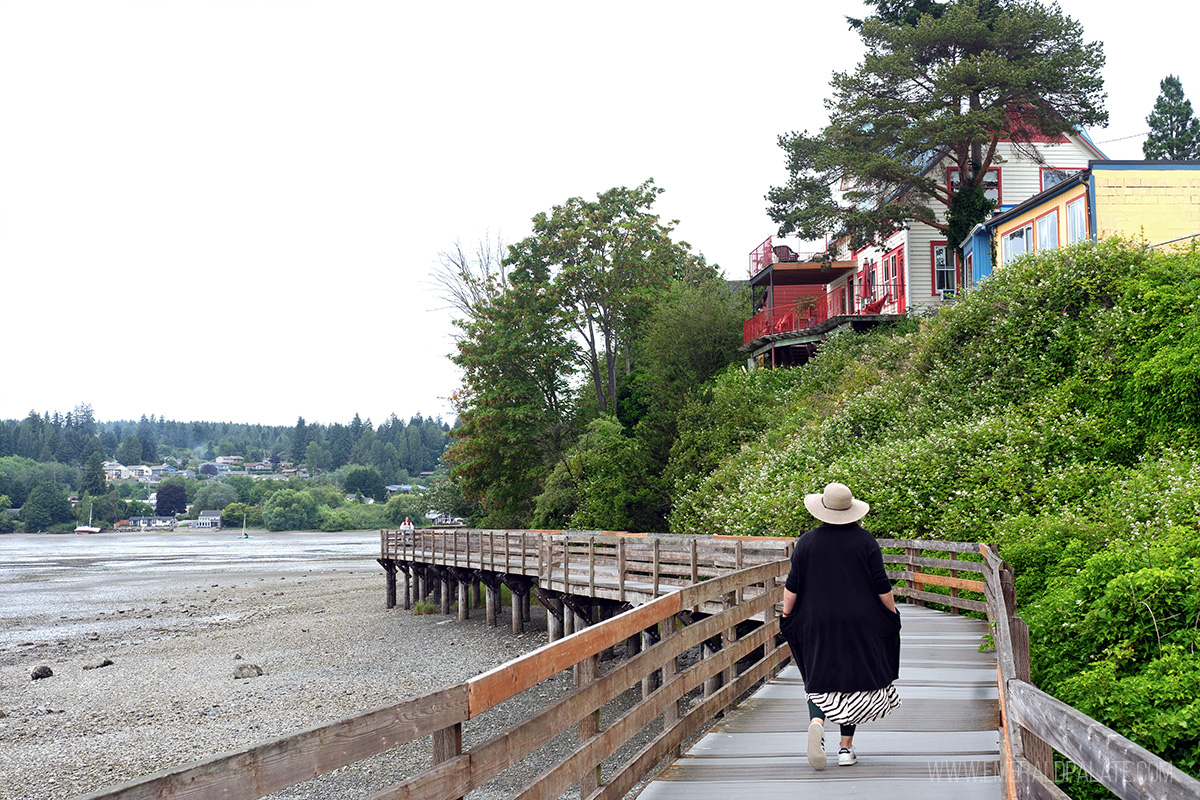 woman walking along a boardwalk in Poulsbo, WA