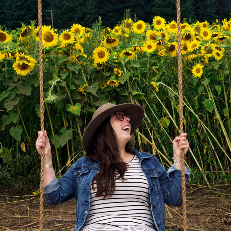 woman on a swing in a sunflower field, one of the best things to do in Seattle in August