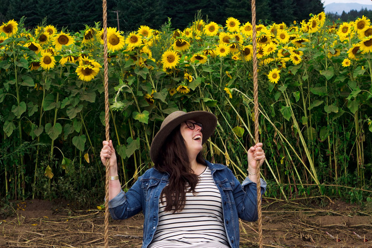 woman on a swing in a sunflower field, one of the best things to do in Seattle in August