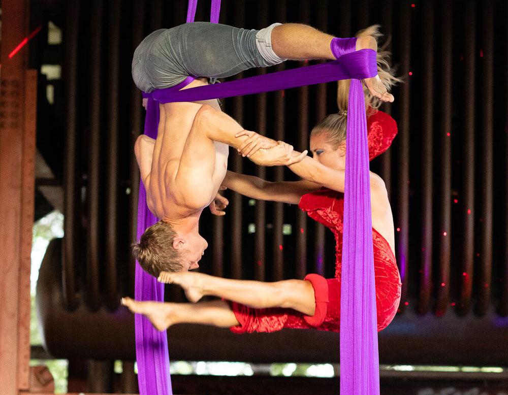 Man and woman doing an acro performance