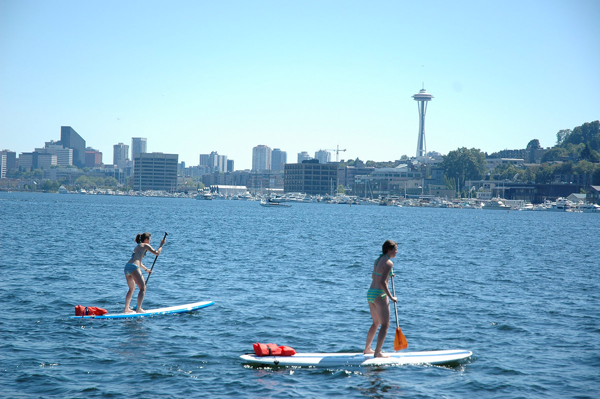 two woman paddle boarding in Seattle