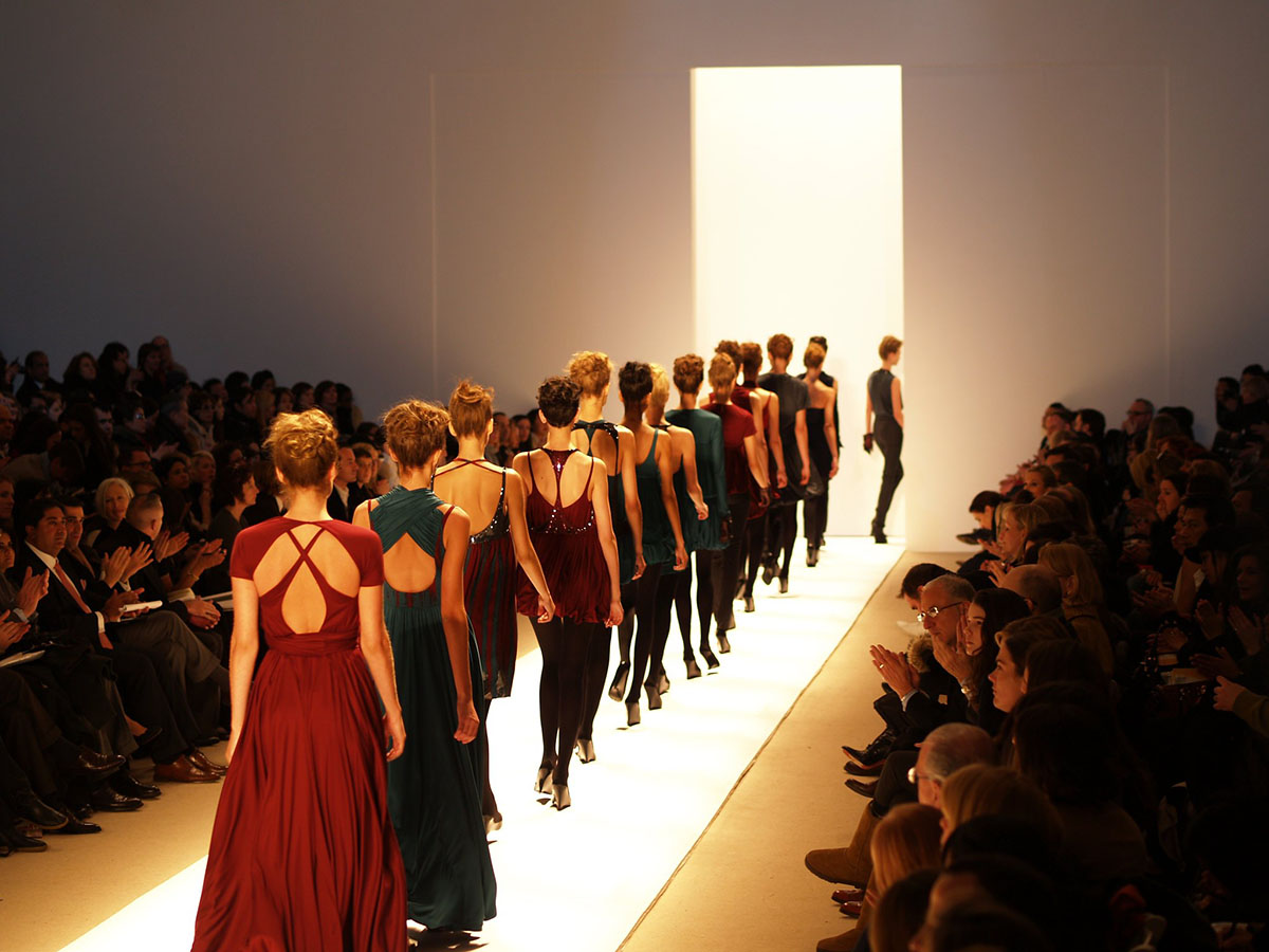 woman walking a catwalk at a fashion show