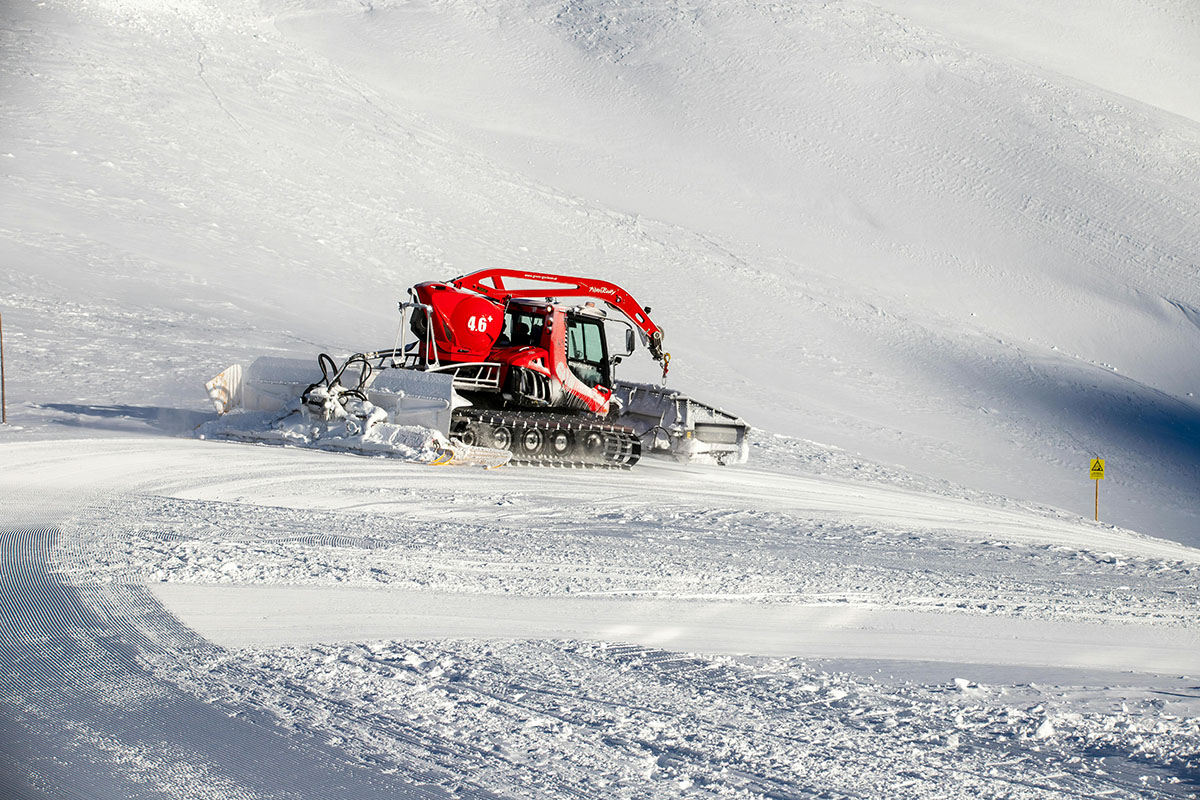 snowcat plowing snow on a trail