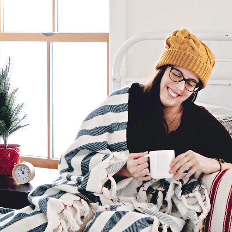 woman cozy in a blanket during winter with coffee, one of the best things to do in Seattle in December