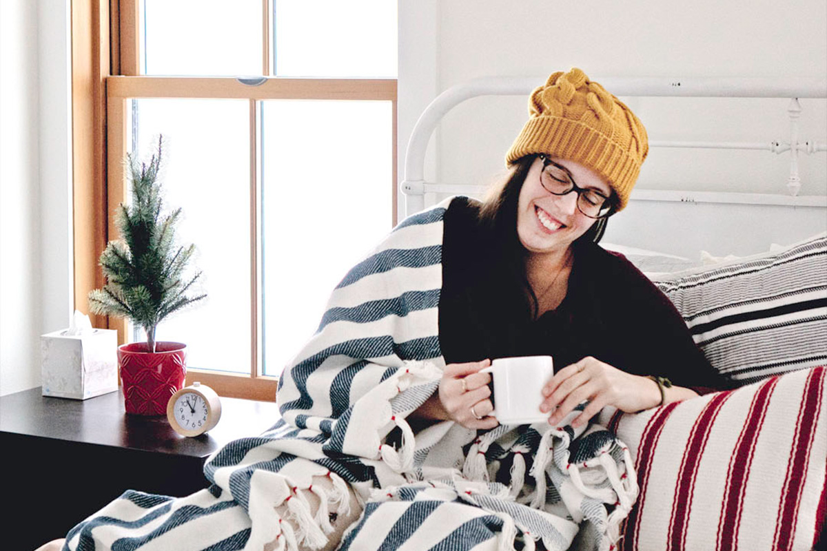 woman cozy in a blanket during winter with coffee, one of the best things to do in Seattle in December