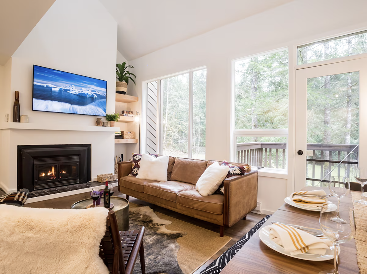 Inside a cabin with vaulted ceilings and floor-to-ceiling fireplace