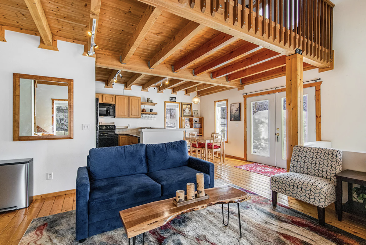 inside a cabin with vaulted ceilings and lofted space