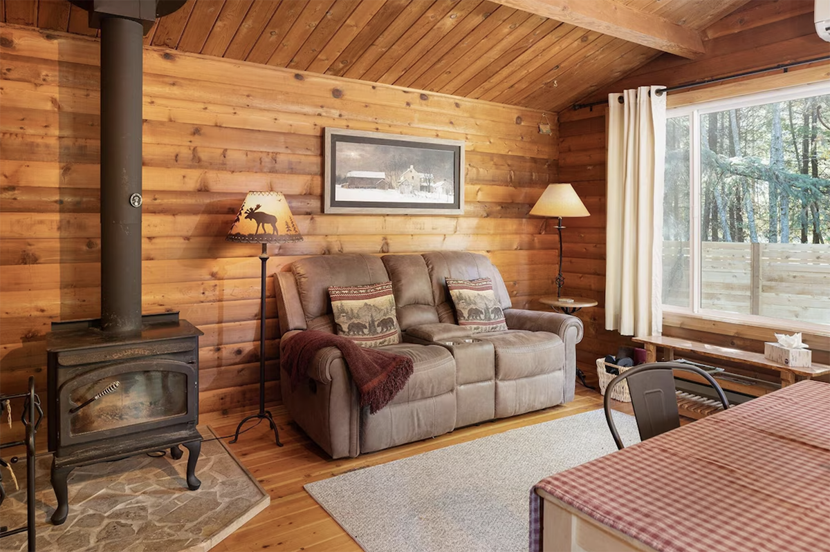 living room inside a log cabin with a wood-burning stove