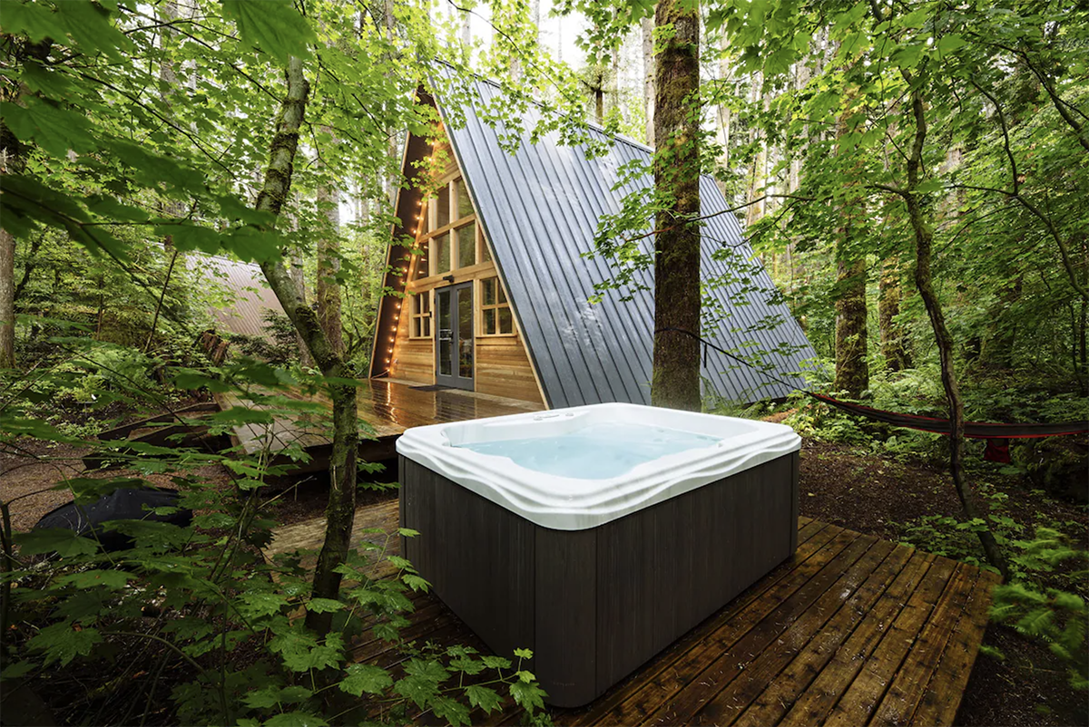 a-frame cabin nestled in the woods with a hot tub at one of the best ski resorts in Washington