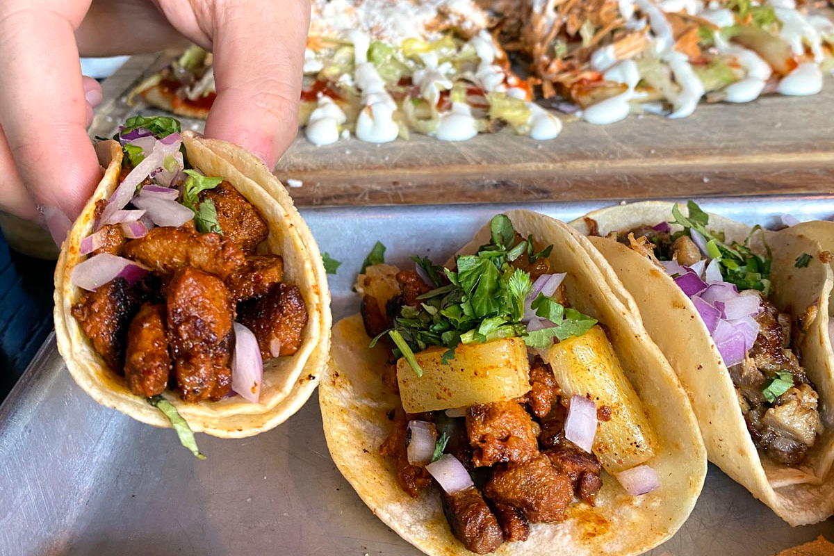 person picking up street tacos from one of the best restaurants in Beacon Hill, Seattle Washington