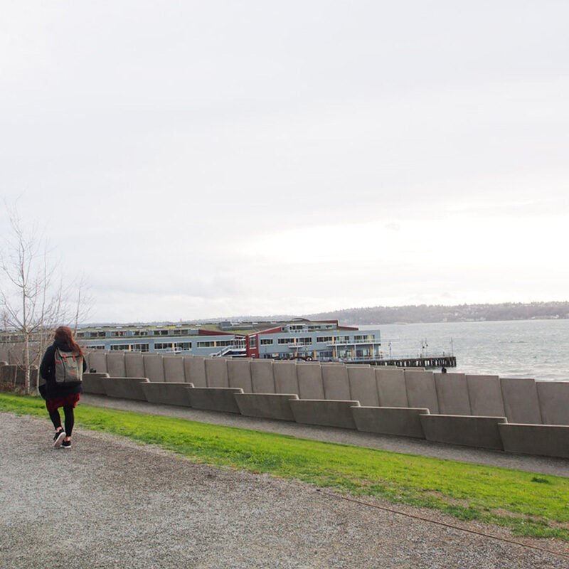 woman walking along the waterfront in winter, one of the best things to do in Seattle in winter