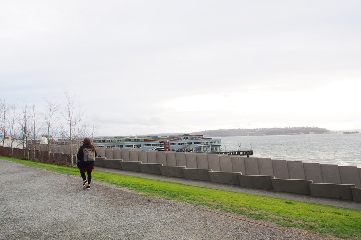 woman walking along the waterfront in winter, one of the best things to do in Seattle in winter