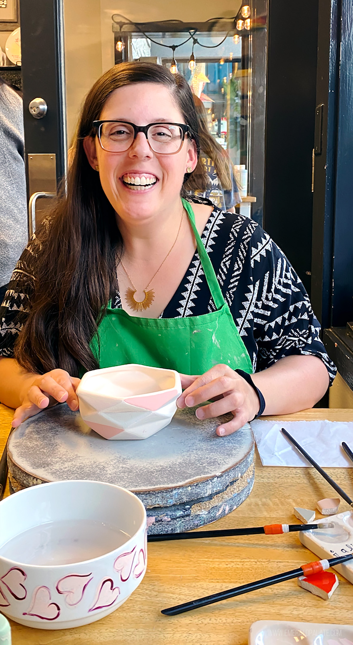 woman painting pottery, one of the best Seattle birthday ideas