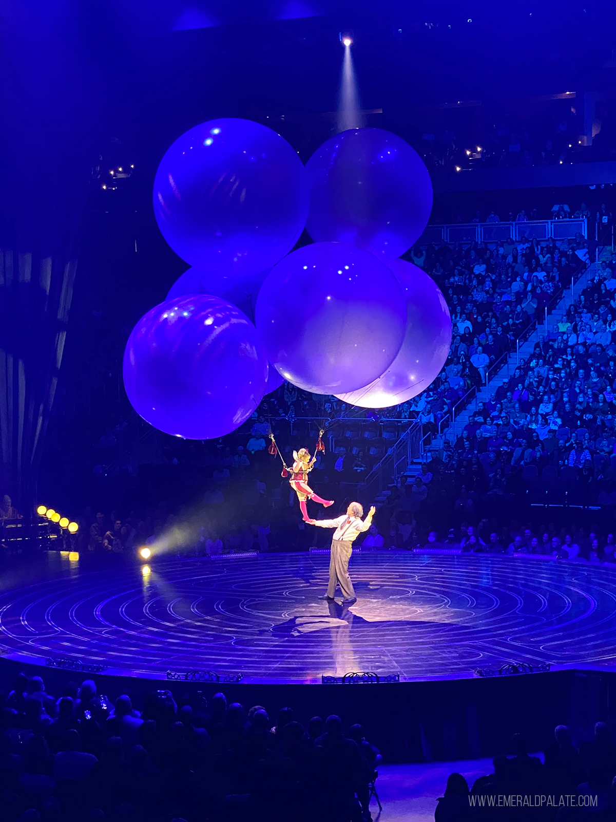 woman floating on balloons on a stage at a Cirque due Soleil show