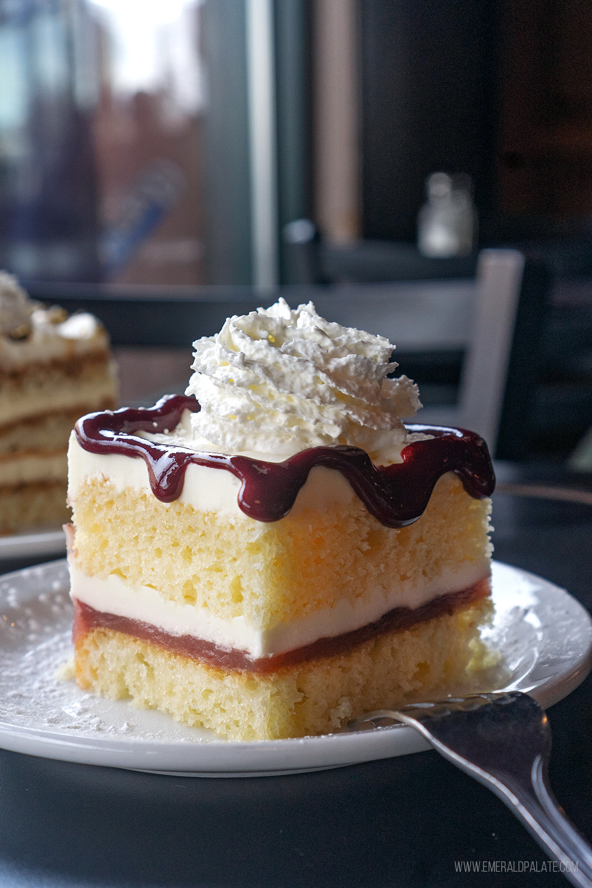 strawberry shortcake with whipped cream and raspberry jam drizzle