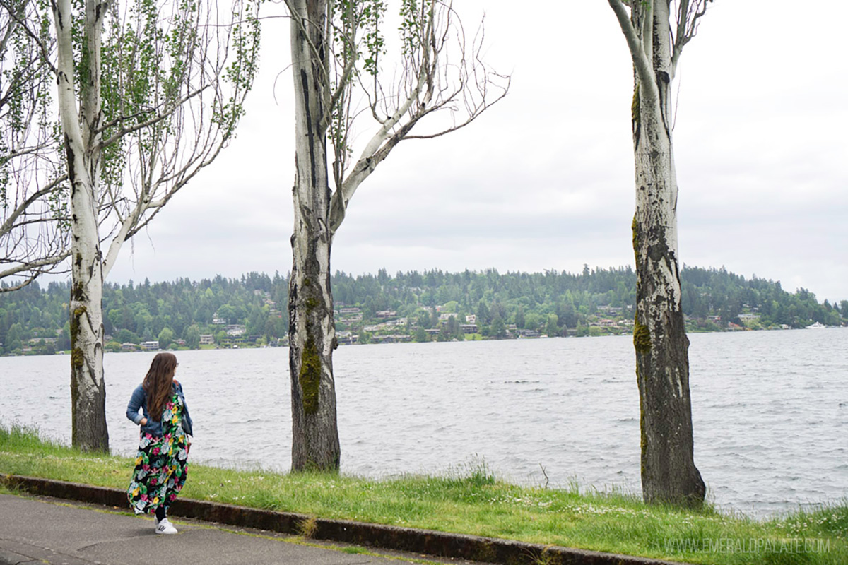 woman walking along a trail in a park, one of the best things to do alone in Seattle