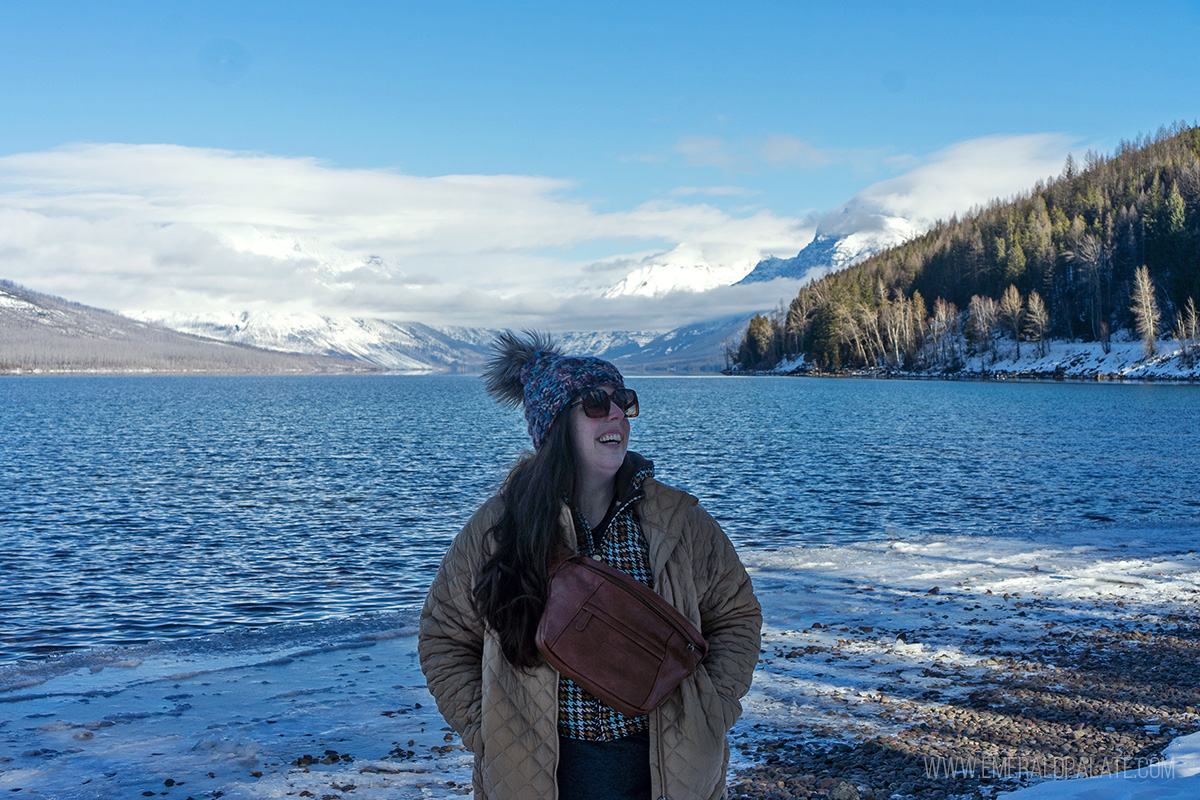 woman laughing in front of Lake McDonald in Glacier National Park