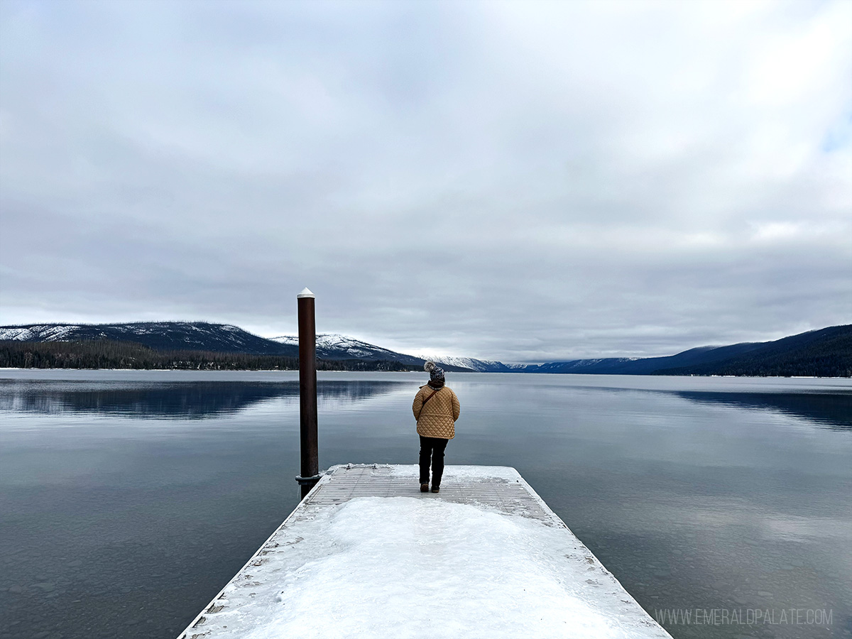 woman taking in the views of Lake McDonald from a dock